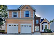 Two-story house with peach siding, two-car garage, and landscaping at 108 Kindlewood Dr, Durham, NC 27703