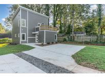 Two-story home with gray siding, a deck, and a concrete driveway at 112 N Guthrie Ave # A, Durham, NC 27703