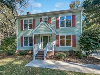 Two story light green house with red shutters at 2504 Timothy Dr, Fuquay Varina, NC 27526