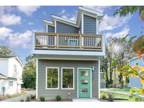 Modern two-story home with a green door and balcony at 112 N Guthrie Ave # C, Durham, NC 27703