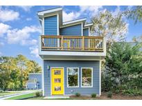 Two-story modern home with blue siding and yellow door at 112 N Guthrie Ave, Durham, NC 27703