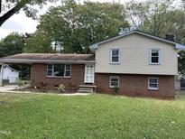 Brick and vinyl-sided two-story house with a landscaped yard and attached carport at 3704 Huntleigh Dr, Raleigh, NC 27604