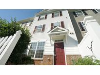 Exterior view of a townhome with red door at 1121 Consortium Dr # 110, Raleigh, NC 27603