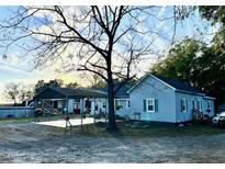 Exterior view of a charming house with a large backyard and detached shed at 283 Pump Station Rd, Erwin, NC 28339