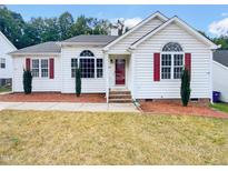One-story house with white siding, red shutters, and landscaping at 6849 Coventry Ridge Rd, Raleigh, NC 27616