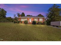 Brick ranch house with spacious lawn and driveway at 95 Windsor St, Goldston, NC 27252