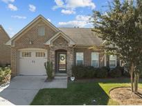 Brick home with two-car garage and landscaping at 1926 Tweed Ln, Burlington, NC 27215