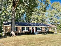 Brick ranch home with mature trees and a large yard at 1016 Driftwood Dr, Siler City, NC 27344