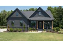 Modern farmhouse exterior with dark siding at 1565 Bowers Store Rd, Siler City, NC 27344
