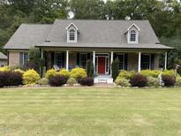 Brick home with a large front porch and well-manicured landscaping at 936 Elbridge Dr, Raleigh, NC 27603