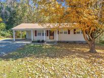 Ranch home with carport and mature trees at 112 Bradsher Rd, Roxboro, NC 27574