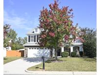 Two-story house with a white exterior, two-car garage, and landscaping at 108 Sleeper Car Ln, Garner, NC 27529