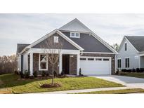Gray-toned two-story house with white garage door and landscaped lawn at 1230 Linkwood, Homesite 44, Fuquay Varina, NC 27526