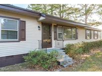 House exterior with light beige siding, brown accents and a front porch at 435 Tant Rd, Zebulon, NC 27597