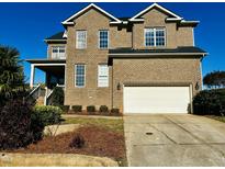 Two story brick home with a large attached garage at 457 Oak Alley Trl, Clayton, NC 27527
