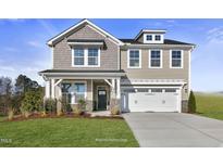Two-story home with a neutral color scheme, two-car garage, and landscaping at 23 Eagle Crest Ct # Holly English Country, Lillington, NC 27546