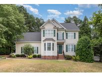 Two-story home with beige siding and green shutters at 5505 Linkside Ct, Fuquay Varina, NC 27526