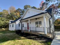 White farmhouse-style home with red door and porch at 2710 - A Mansfield Ave, Durham, NC 27703