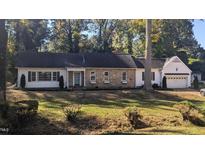 Charming ranch home with stone accents and a two-car garage at 223 Willowood Dr, Henderson, NC 27536