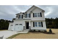 Two-story home with a two-car garage and landscaping at 726 Sherrill Farm Dr, Benson, NC 27504