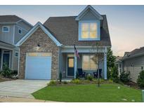 Two-story house with brick and gray siding, and two-car garage at 137 Swain St, Clayton, NC 27527