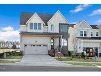 Two-story modern farmhouse style home with gray and white exterior at 465 Douglas Falls Dr, Wendell, NC 27591