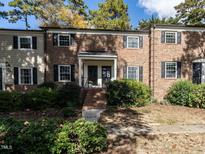 Brick townhouse with double front doors, steps, and landscaping at 3736 Jamestown Cir, Raleigh, NC 27609