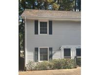 Gray vinyl sided duplex with shutters and landscaping at 1111 Nottingham Cir, Cary, NC 27511