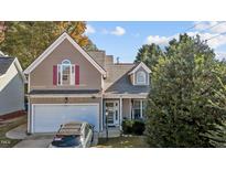 Two-story house exterior with taupe siding and attached garage at 2125 Star Sapphire Dr, Raleigh, NC 27610