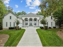 Grand estate home with a circular driveway and manicured lawn at 90118 Hoey, Chapel Hill, NC 27517