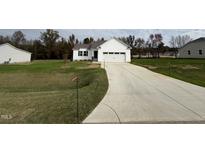 White house exterior with a two-car garage and driveway at 378 Magnolia Run Way, Benson, NC 27504
