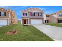 Two-story house with a brown and beige exterior, a two-car garage, and a well-manicured lawn at 1915 Puffin Dr # 198, Haw River, NC 27258