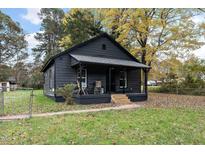 Dark gray house with a covered porch and landscaping at 617 Orange Heights Loop Rd, Hillsborough, NC 27278