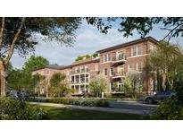 Brick building exterior with balconies and landscaping at 2606 Marchmont St # 102, Raleigh, NC 27608