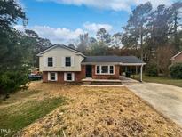 Charming ranch home with a brick facade and attached carport at 1526 Clermont Rd, Durham, NC 27713