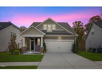 Curb appeal abounds at this charming craftsman home, featuring a two-car garage and inviting front porch at 12309 Aberdeen Chase Way, Durham, NC 27703