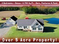 Aerial view of 5+ acre property with house, barn, pond, pastures at 3750 Massey Holt Rd, Princeton, NC 27569