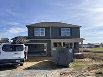 Two-story house with a gray exterior, attached garage, and visible landscaping at 48 Silver Ct, Smithfield, NC 27577