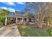 Charming one-story home with a large front porch and mature trees at 611 Olive St, Apex, NC 27502