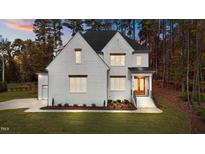 Two-story home with white brick exterior, landscaping, and a two-car garage at 2105 Gentry Rd, Wake Forest, NC 27587