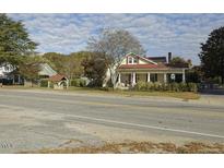 Two-story house with front porch, visible from across the road at 715 E Broad St, Fuquay Varina, NC 27526