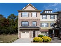 Brick and shingle three-story townhome with a two-car garage at 254 Linden Park Ln Ln, Cary, NC 27519