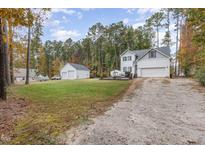 Two-story house with detached garage and spacious backyard at 143 Rawhide Dr, Louisburg, NC 27549