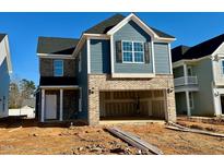 Two-story home with gray siding, brick accents, and attached garage at 87 Nimble Way # 187, Clayton, NC 27520