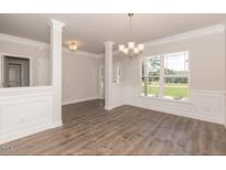Bright dining room with hardwood floors and columns at 110 Lemon Drop Ln, Franklinton, NC 27525