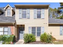 Tan two-story townhome with gray shutters and landscaping at 14 Stone Village Ct, Durham, NC 27704