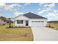 White one-story house with a two-car garage and landscaping at 33 Barony Ln, Smithfield, NC 27577