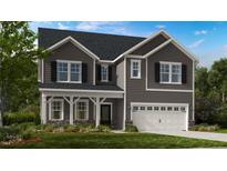 Two story home with gray siding, stone accents, and 3 car garage at 904 Delano Dr, Knightdale, NC 27545