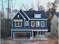 Two-story home with navy siding, white accents, and a covered porch at 3267 Roundly Rd # 8, New Hill, NC 27562