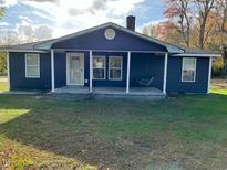 Newly renovated home with a dark blue exterior and front porch at 876 Vanco Mill Rd, Henderson, NC 27537